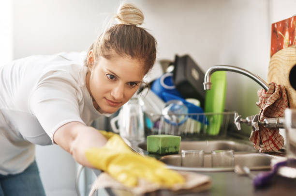 cropped shot of a young woman cleaning her home